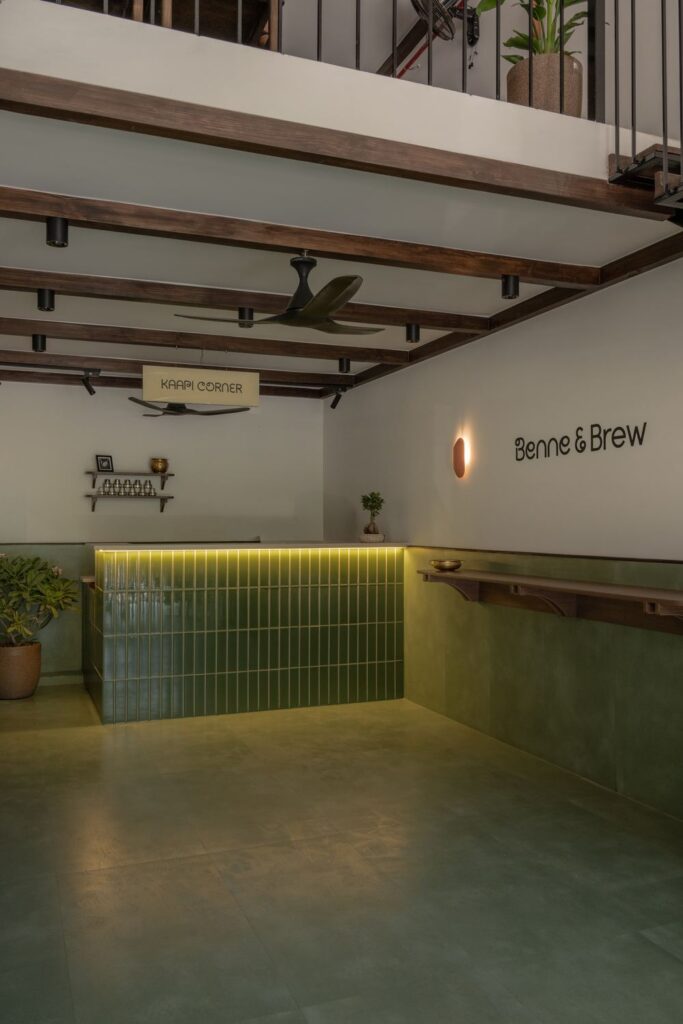 The long counter at Benne & Brew with the Benne & Brew lettering on the cream wall and green tiled front