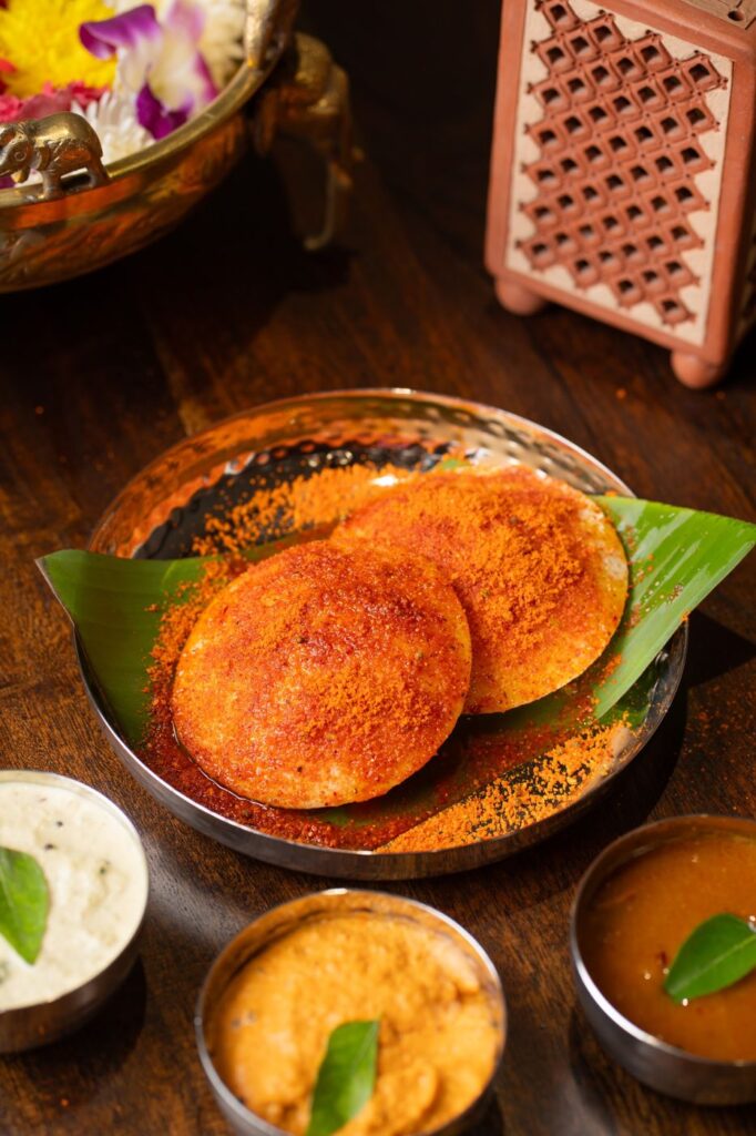 Idlis coated in red chutney podi