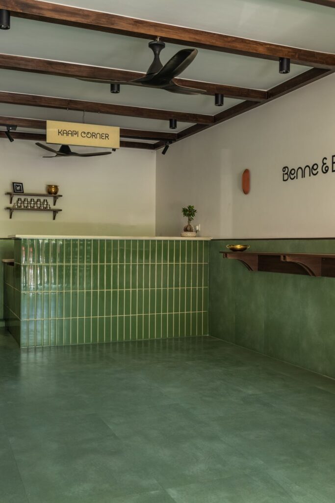 The Kaapi Corner counter at Benne & Brew, Viman Nagar, with green tiled front and wooden beams overhead